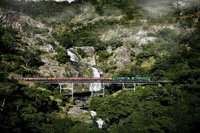 Port Douglas: Kuranda tour with Skyrail or Scenic Train - Taking the Kuranda Scenic Railway: Coral Sea views, waterfalls, and tunnel segments